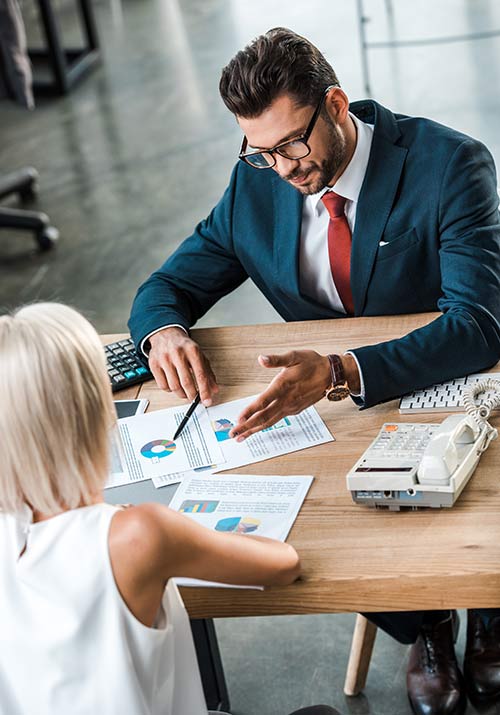 Financial educator reviewing policy options with a client